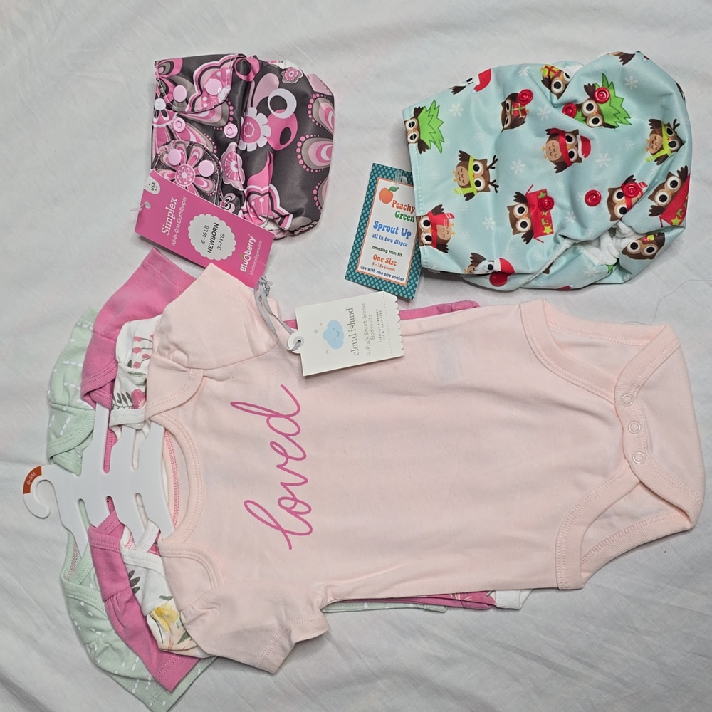 Bundle of 4pack girl onesies and 2 all in one cloth diapers